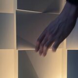 Modernist wall lamp with white metal shade, design by C. Grandidier.