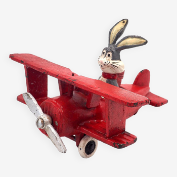 Toy Bugs Bunny figure in a cast iron biplane approximately 1948