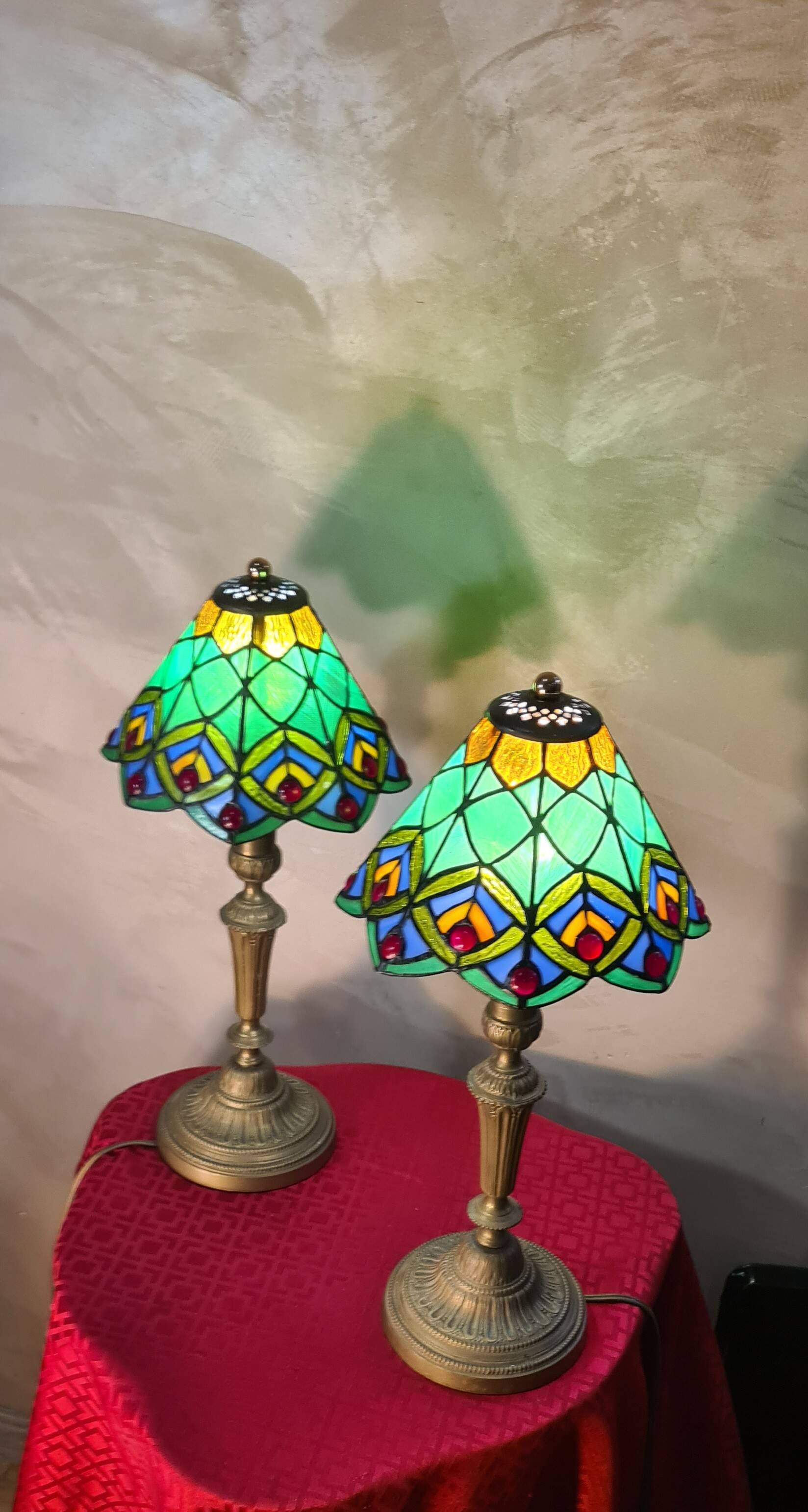 Pair of art nouveau bronze lamps, Tiffany-style glass lampshades