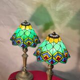 Pair of art nouveau bronze lamps, Tiffany-style glass lampshades
