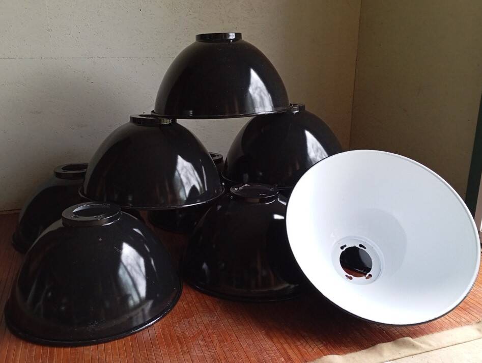 Set of 10 large industrial enamelled metal pendants.