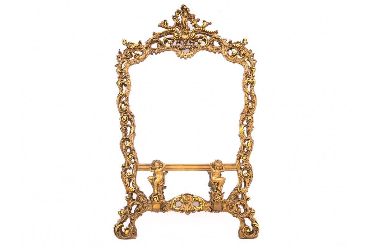 A large mirror in a gold frame, Italy, first half of the 20th century.