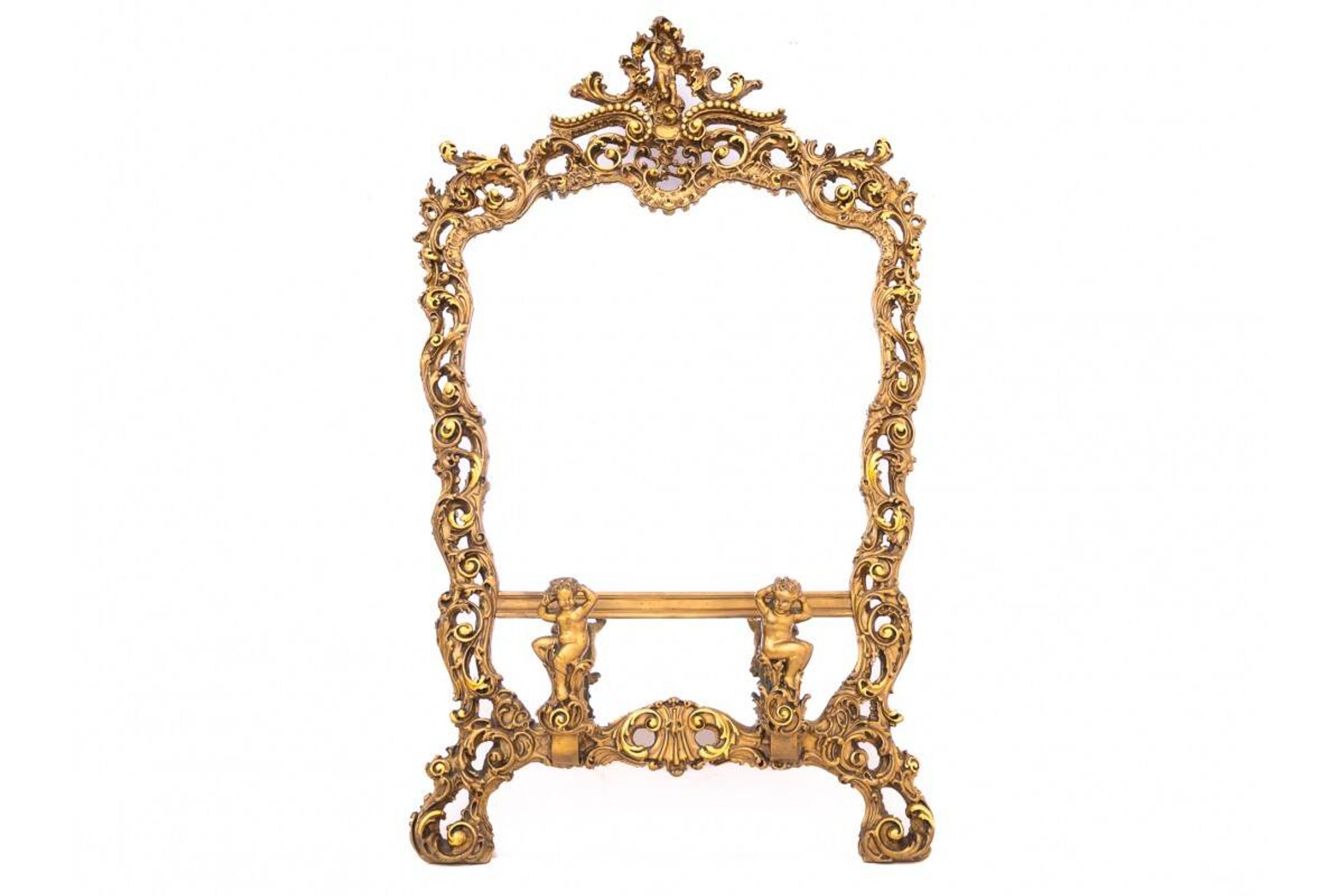 A large mirror in a gold frame, Italy, first half of the 20th century.