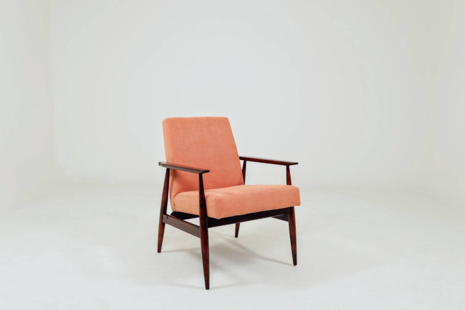 Mid-century modern armchair in coral red designed by H. Lis.