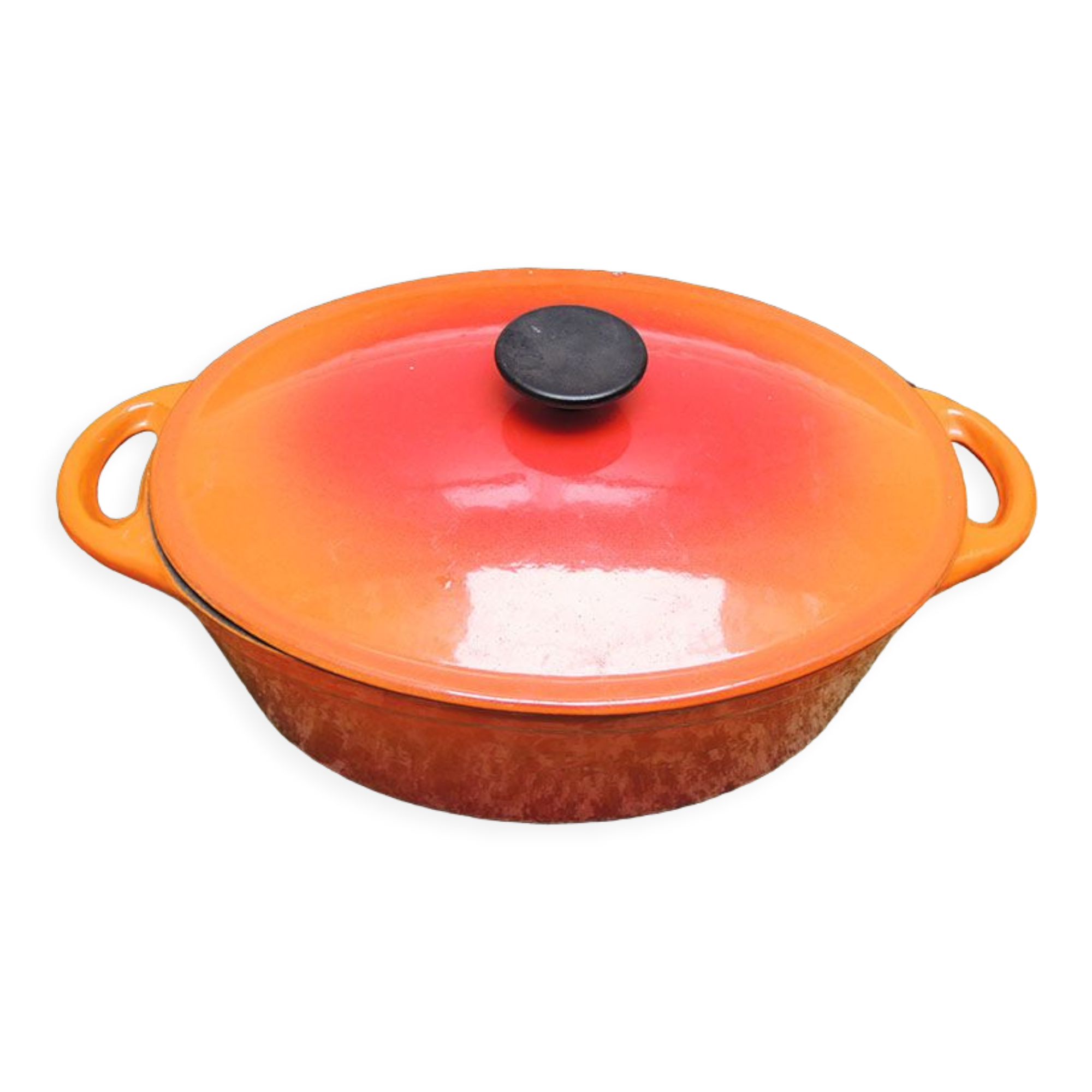 Old oval casserole in orange enamelled cast iron