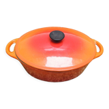 Old oval casserole in orange enamelled cast iron