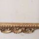 Mirror with a carved wooden frame in an antique style in pure gold.