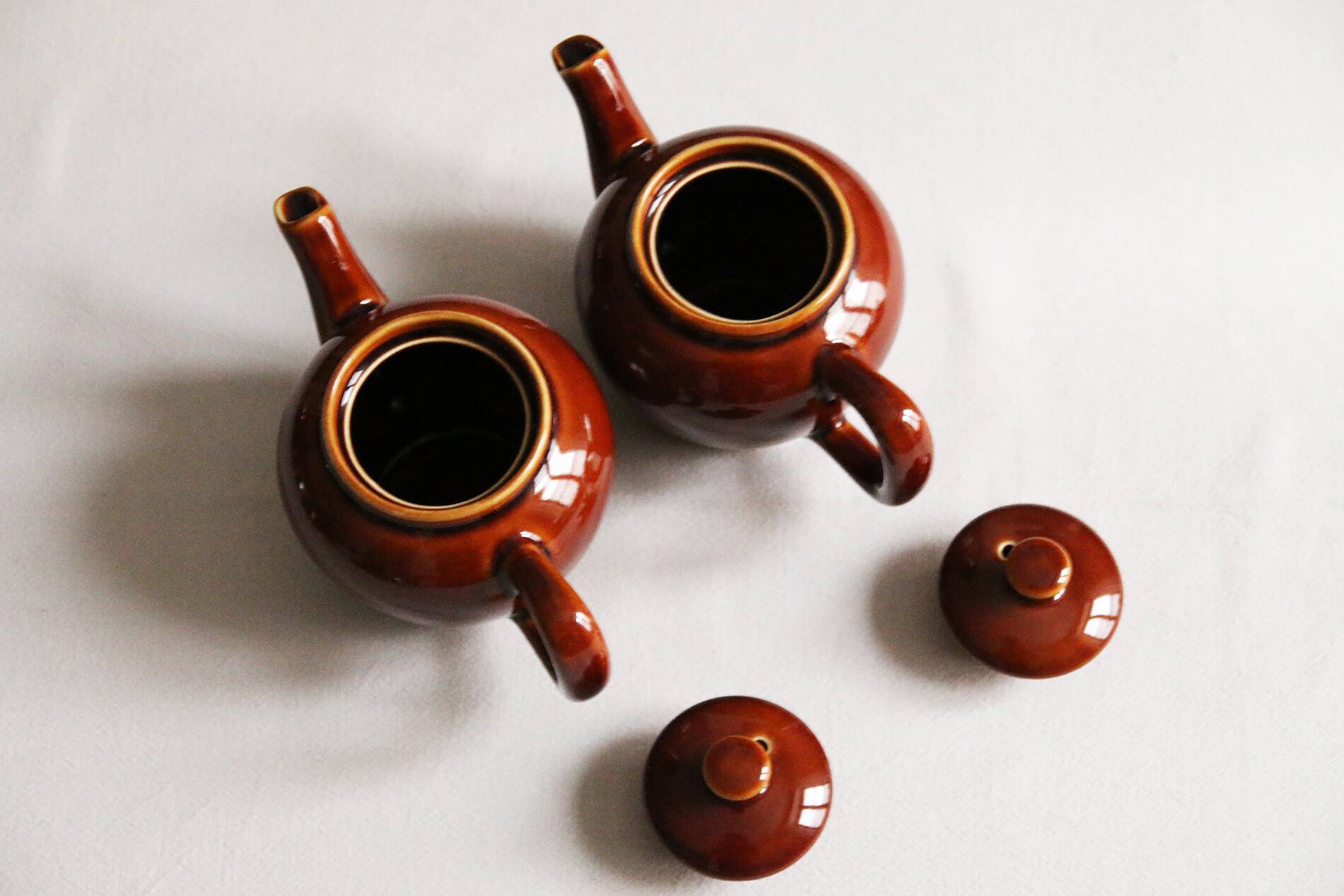 2 brown glazed ceramic teapots
