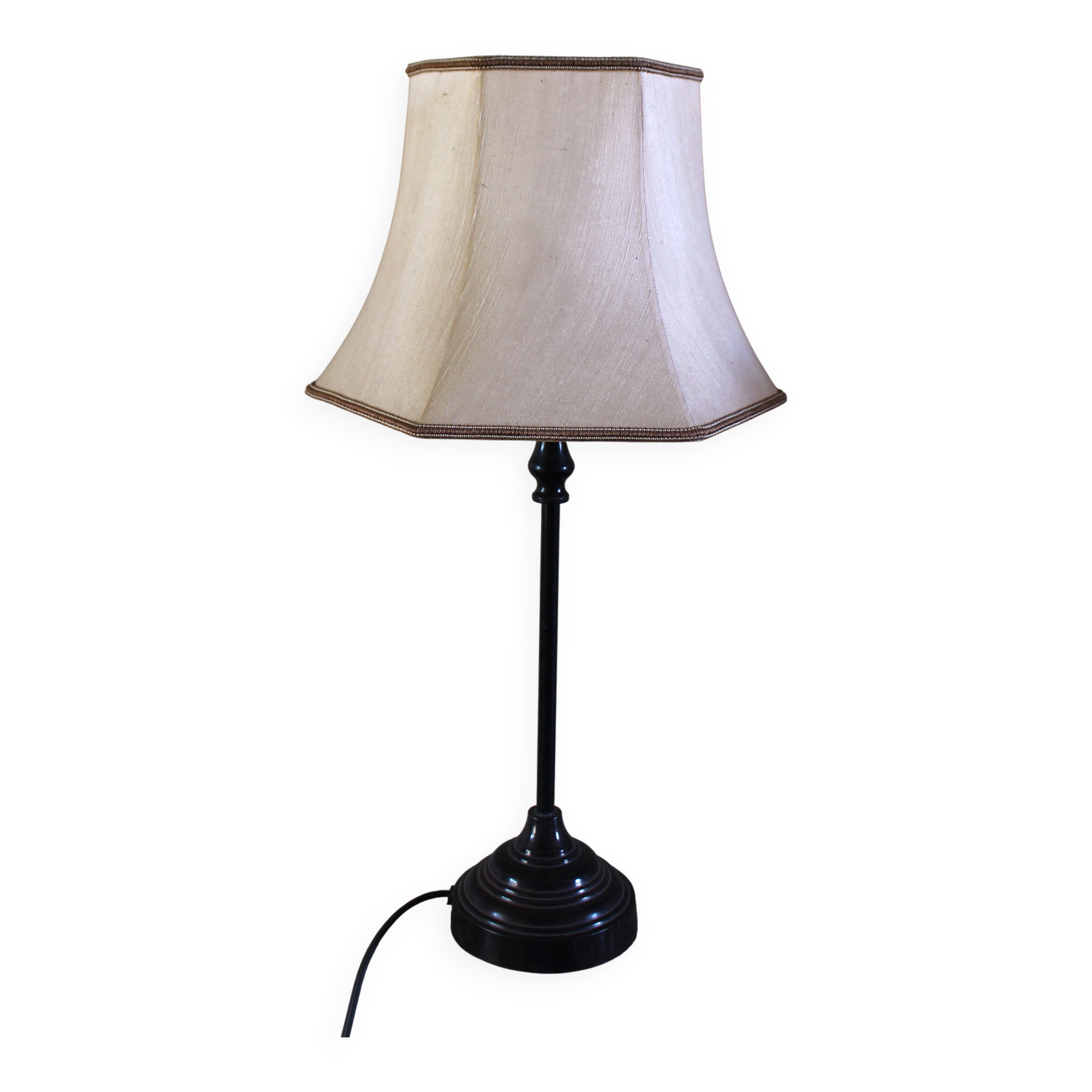 Table lamp with a patinated base and vintage woven shade.