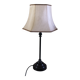 Table lamp with a patinated base and vintage woven shade.