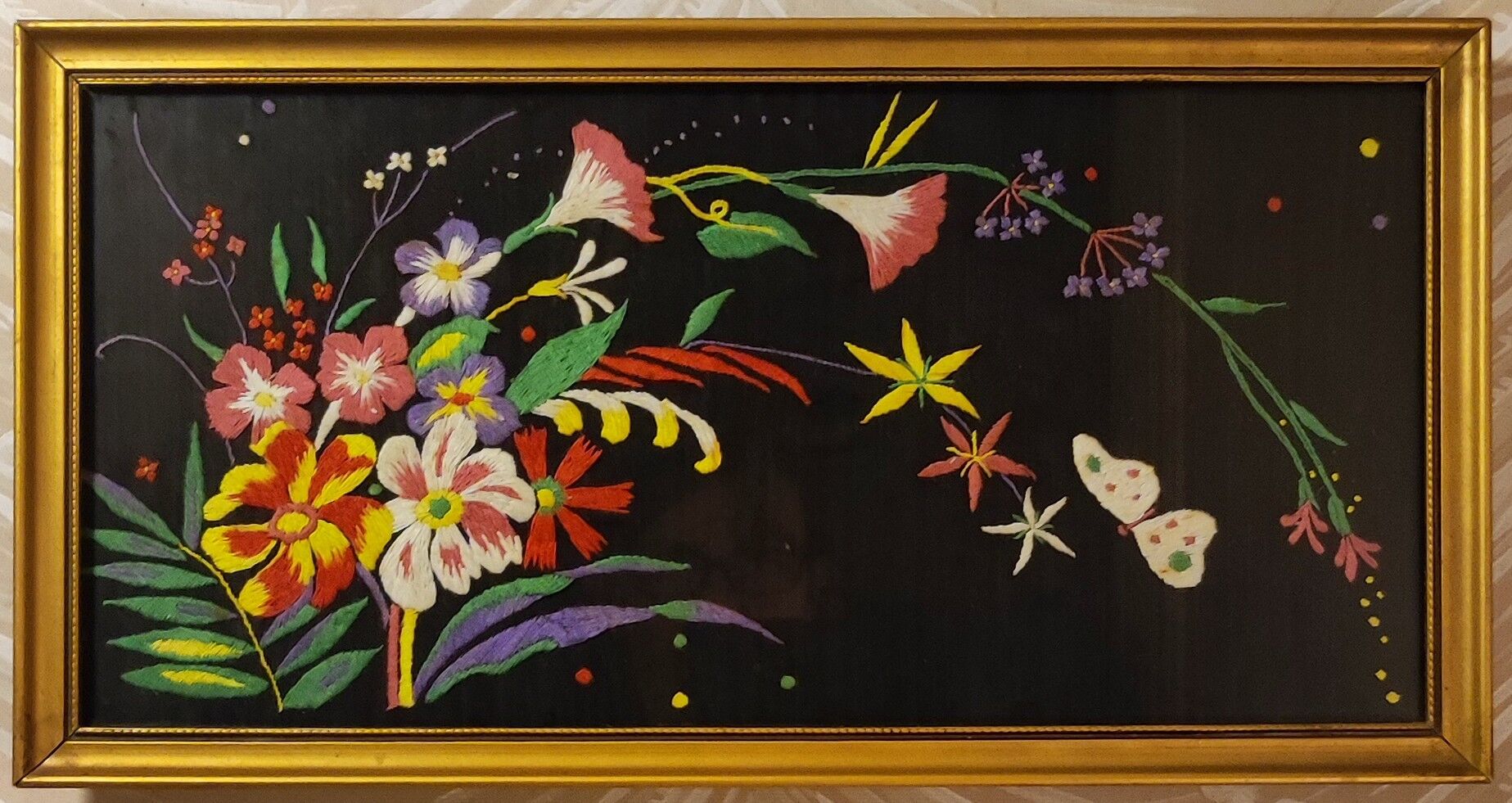 Floral embroidery on black silk framed 1950