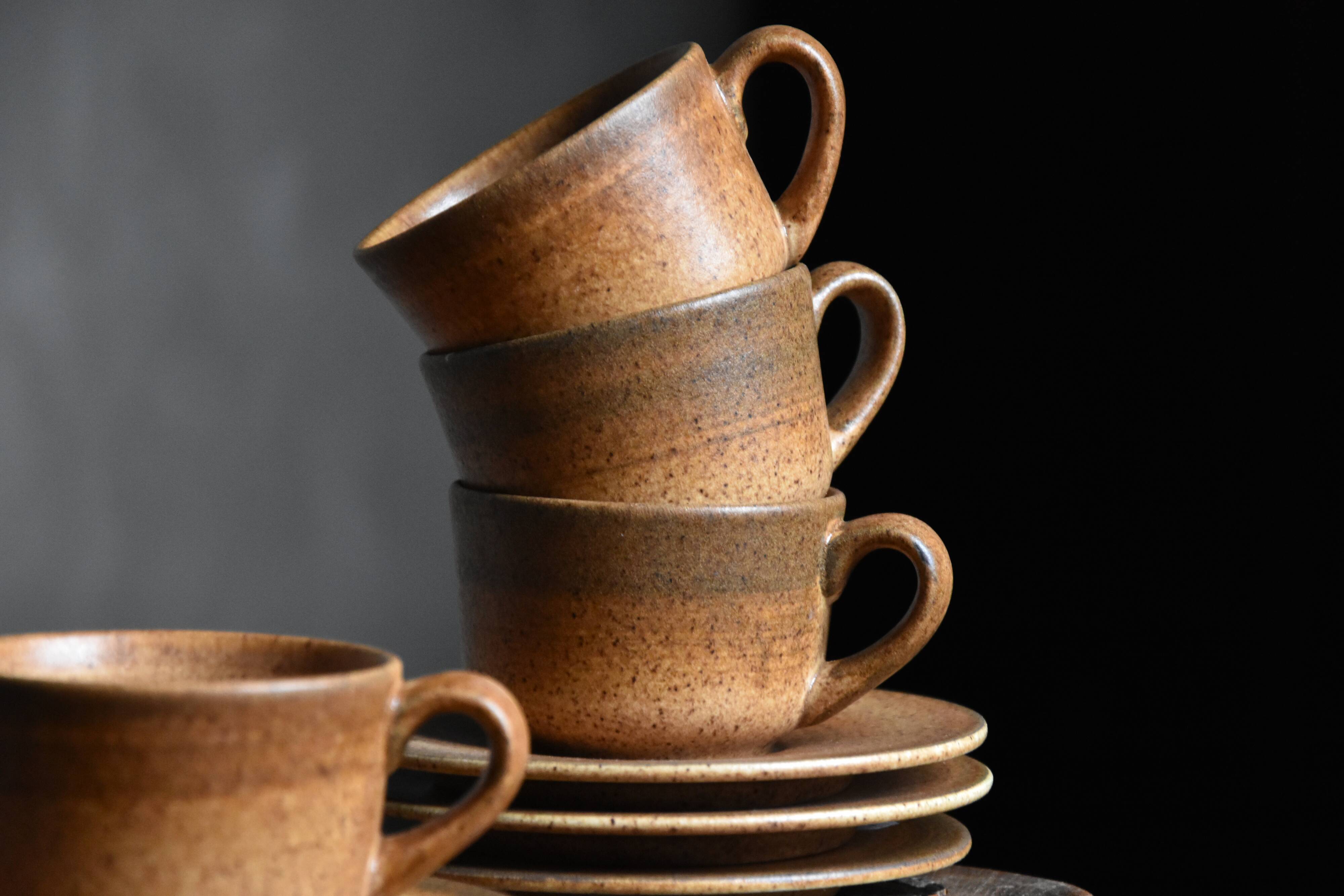 4 sandstone cups and saucers