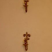 A pair of antique brass wall sconces.