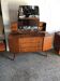 Vintage 1950s brown wooden dressing table with a double mirror and integrated storage.