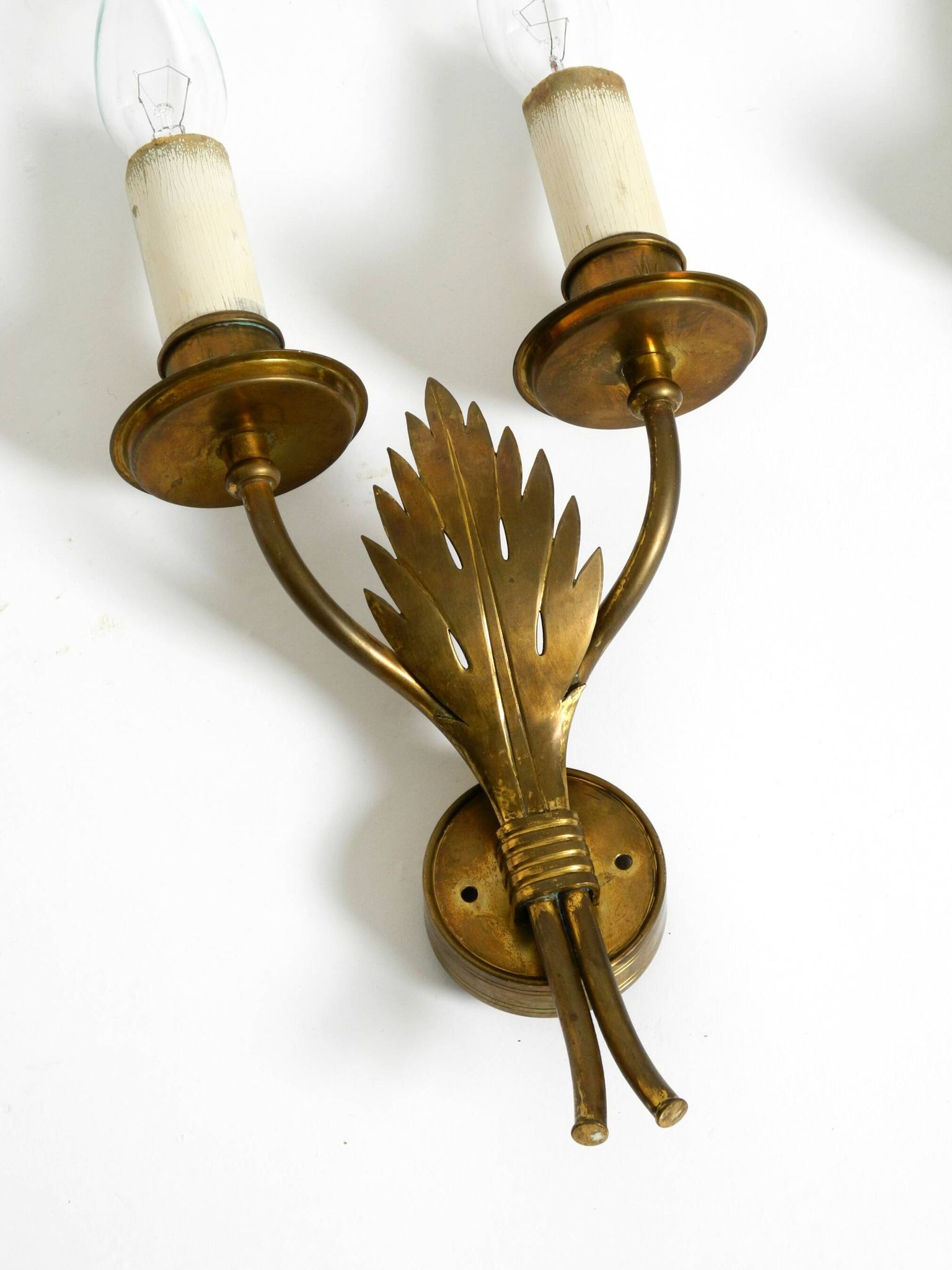 A pair of mid-century modern brass wall lamps by Vereinigte Werkstätten