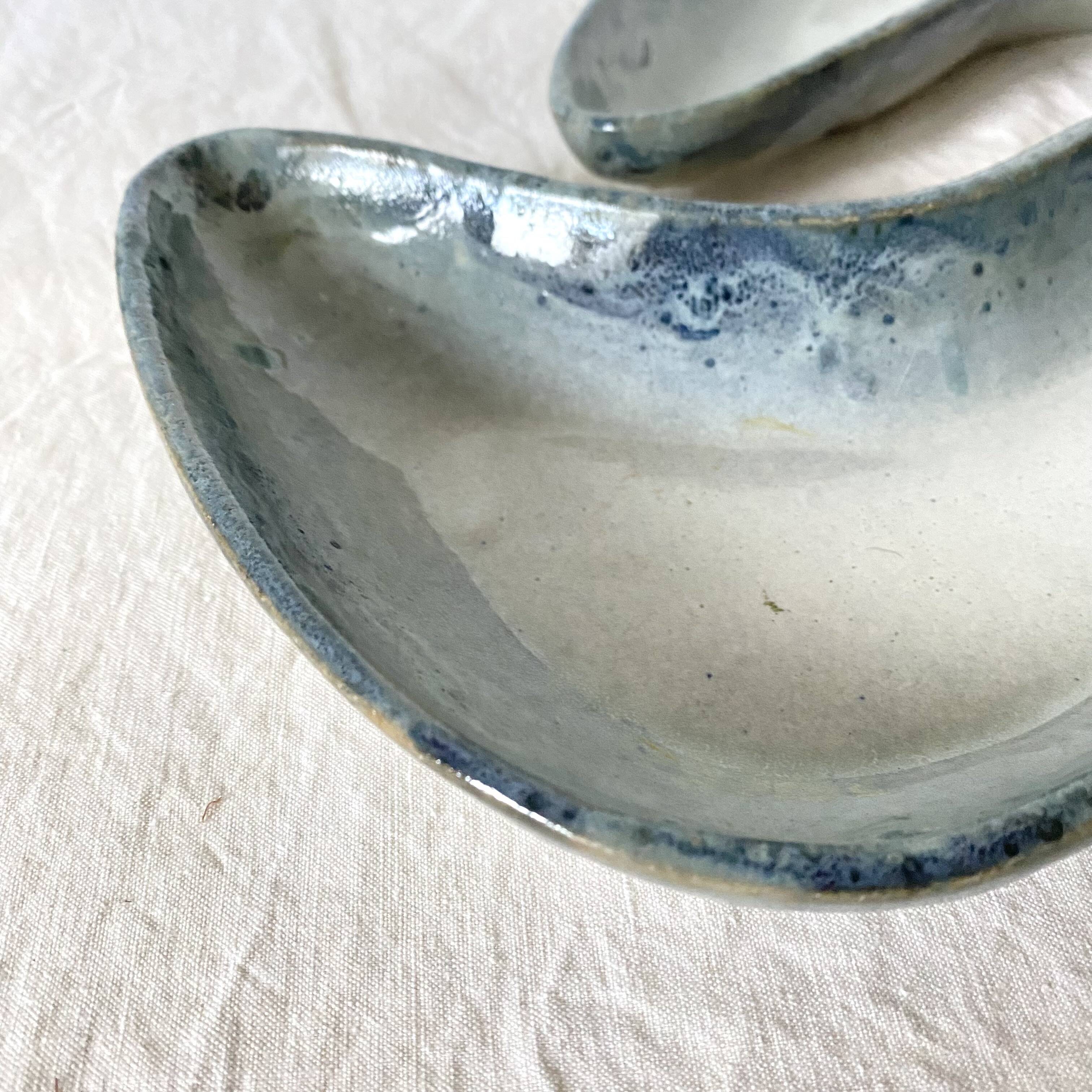 Pair of boomerang dishes signed in enamelled terracotta