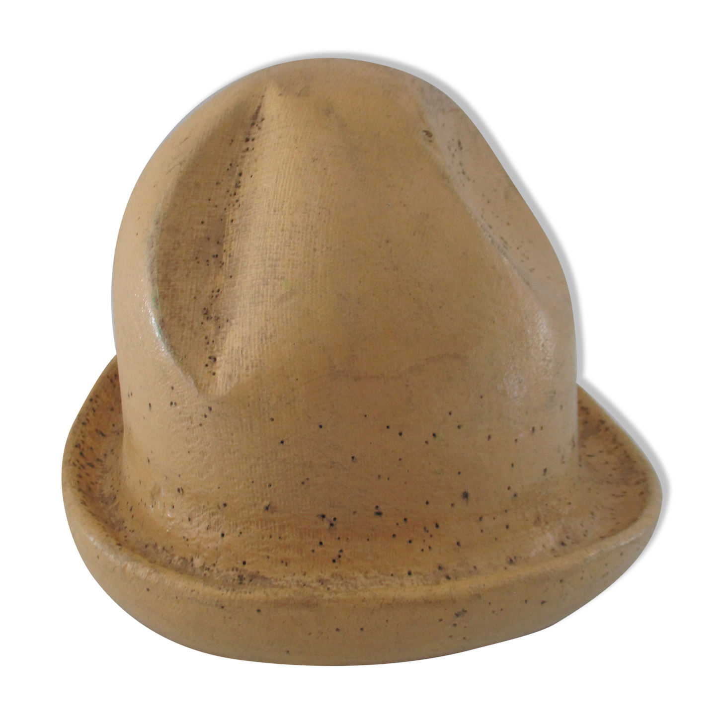 Shape of pressed plaster hat with surface and textile fiber of yellowish color,