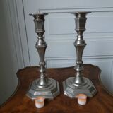 Pair of silver-plated metal candlesticks with cut sides