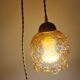 2 iridescent amber luminaires in suspensions