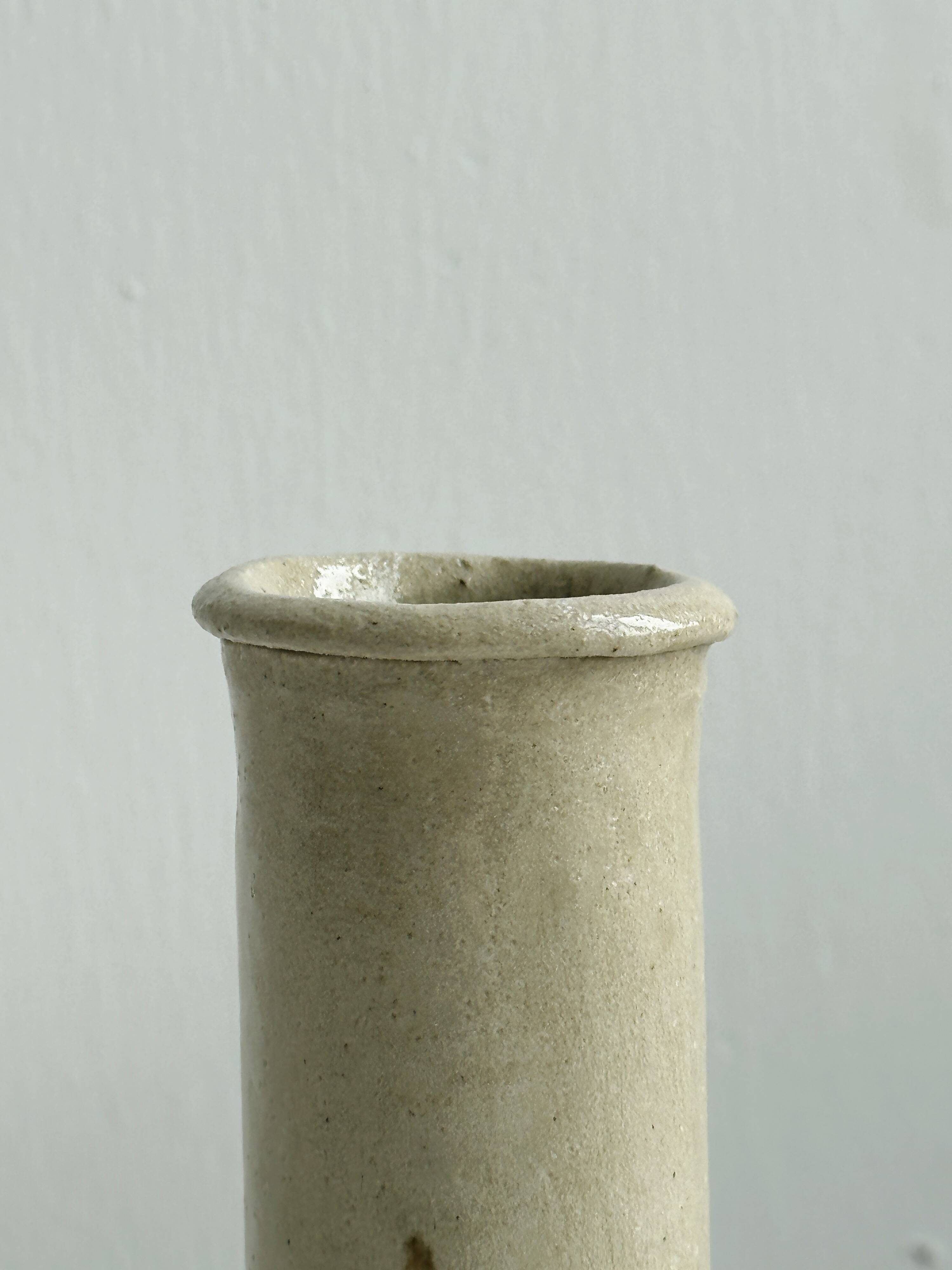 Minimalist beige ceramic vase.