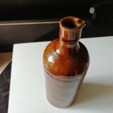 Old bottle in varnished ground.