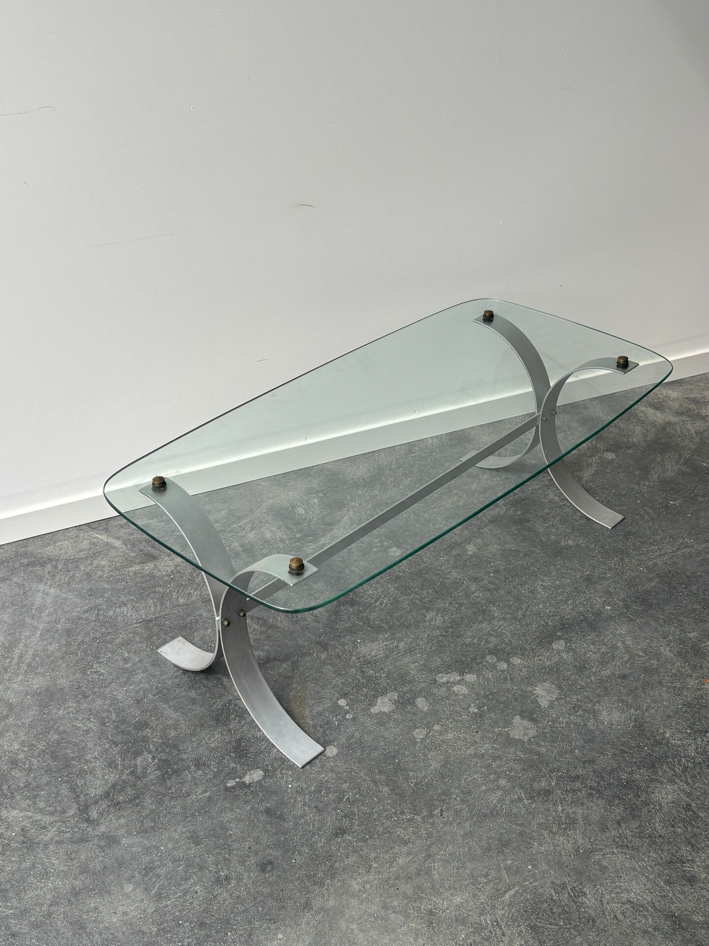 Design coffee table in brushed metal with a glass top, 1970s.