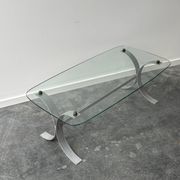 Design coffee table in brushed metal with a glass top, 1970s.