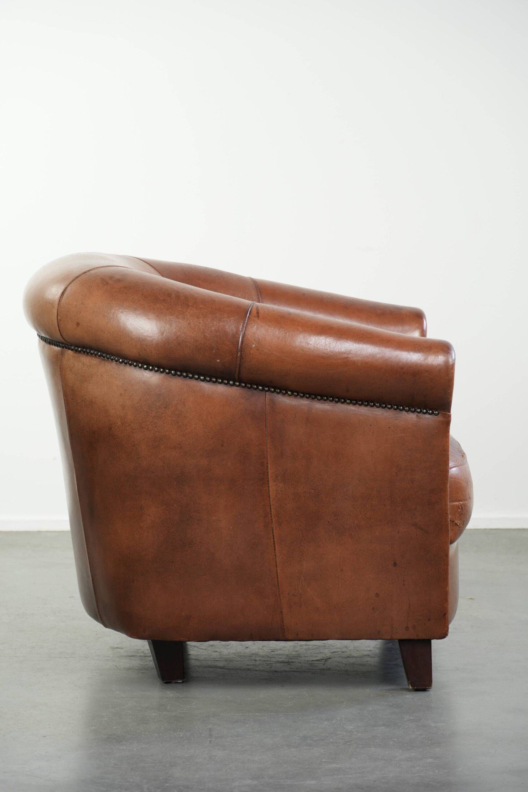 Vintage sheepskin club armchair in English style with deep colours
