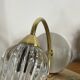 Pair of wall sconces in brass with transparent tulip glass shade.