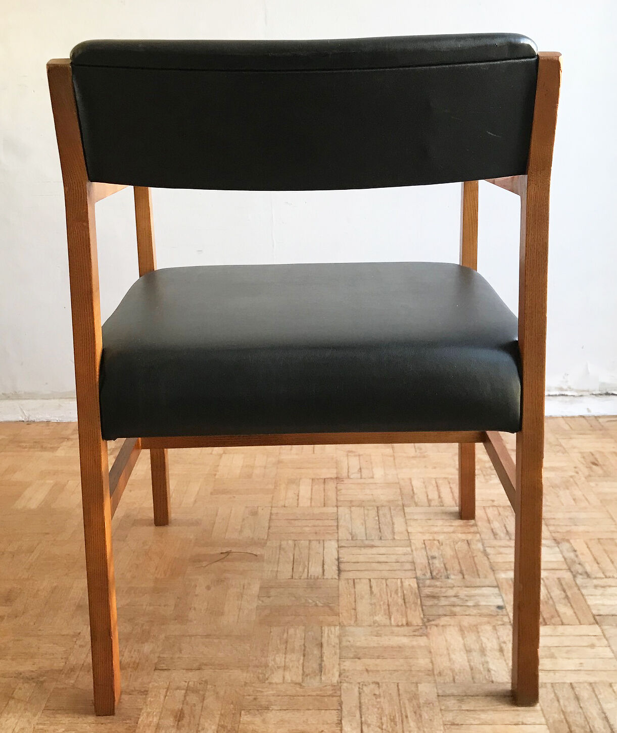 Chair in light teak and black skaï from the 1960s