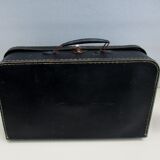 Small suitcase in old navy blue cardboard
