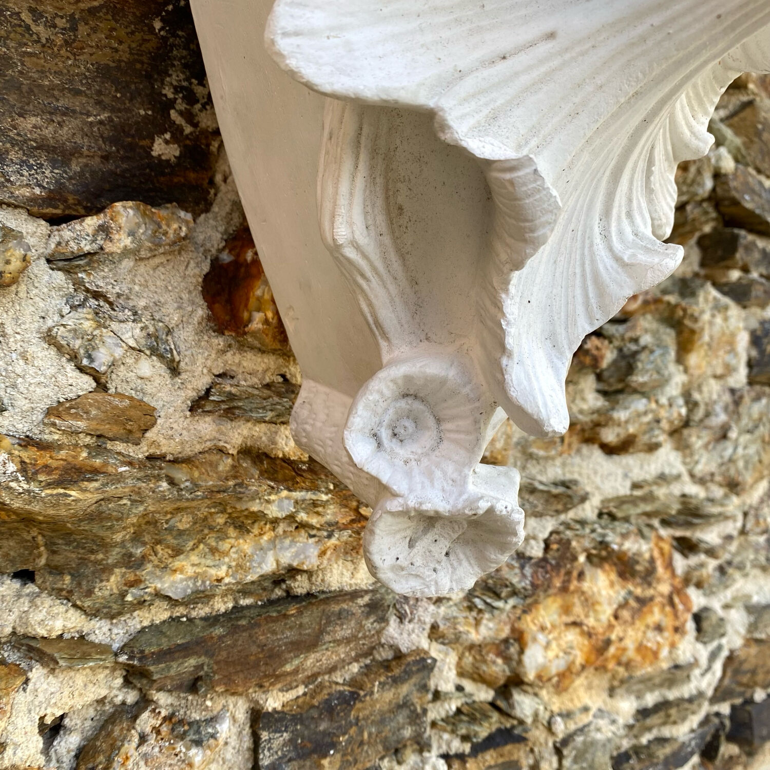 Antique wall console in patinated white plaster.