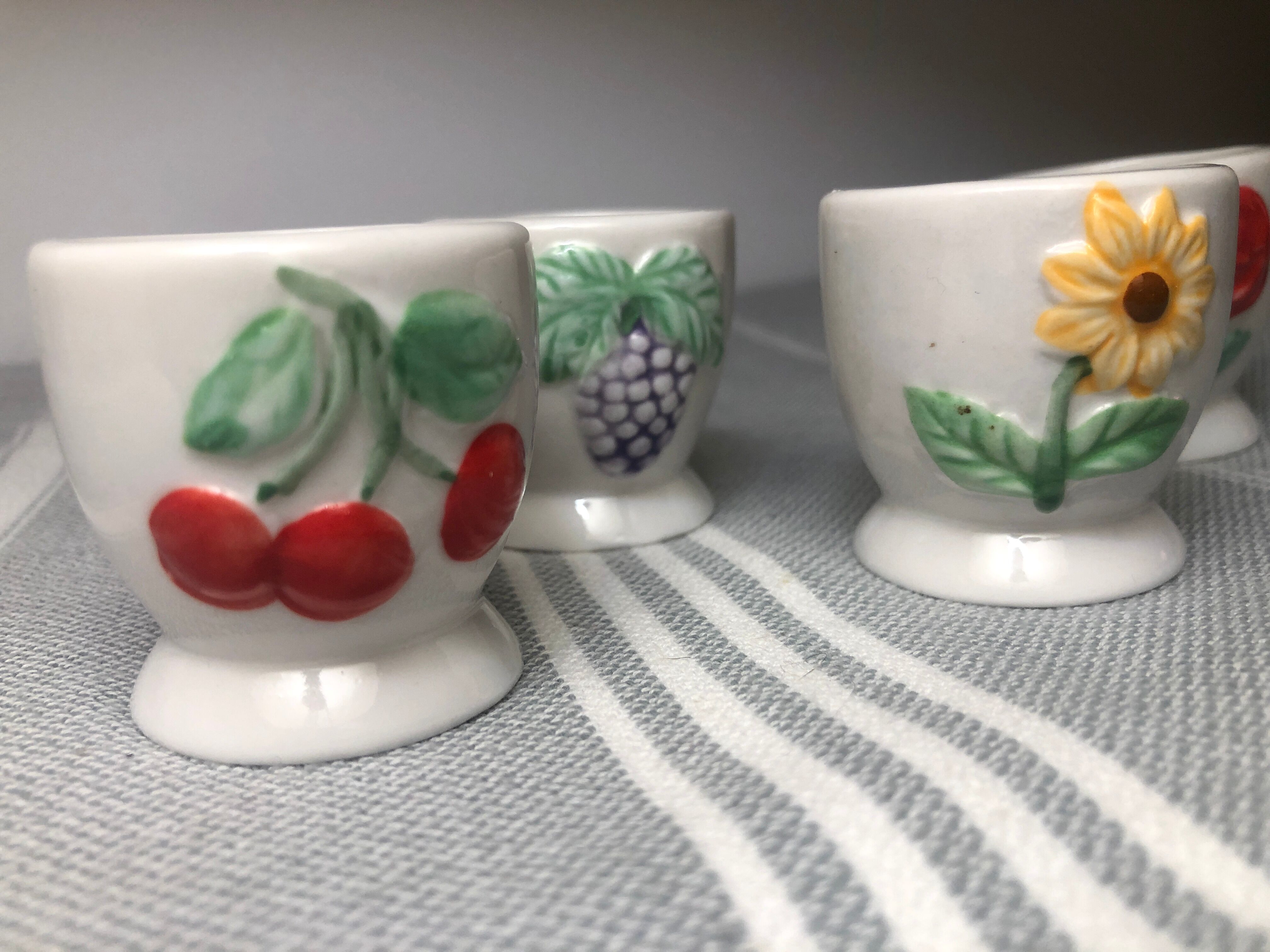 Ceramic shells with relief decoration of flowers (yellow and red) and fruits (cherries and grapes)