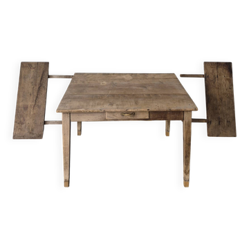 Old farmhouse table with its 2 extensions and raised legs.