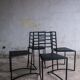 Set of 4 minimalist black steel dining chairs.