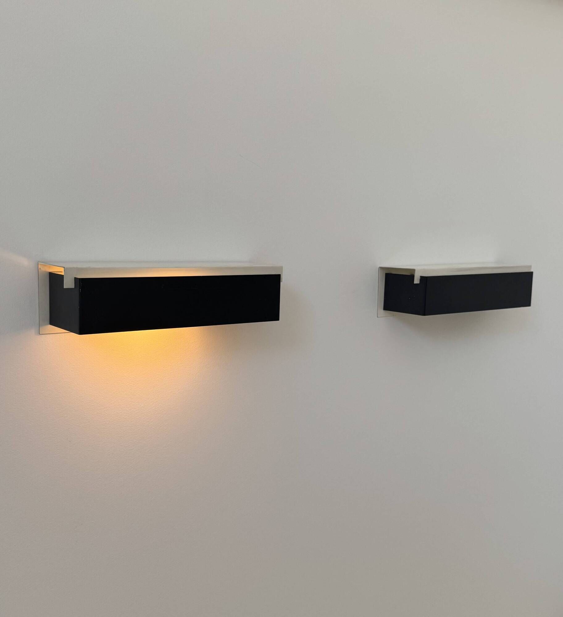 Pair of vintage wall sconces, painted black and white metal, Sweden 1970.
