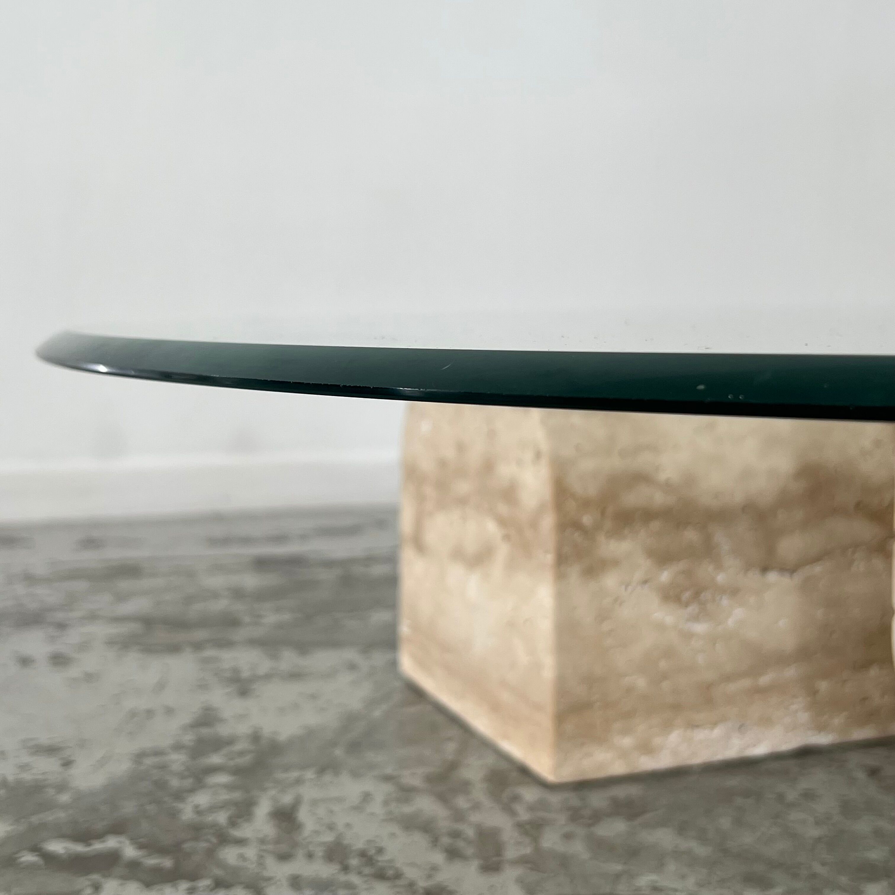 Coffee table in travertine and glass
