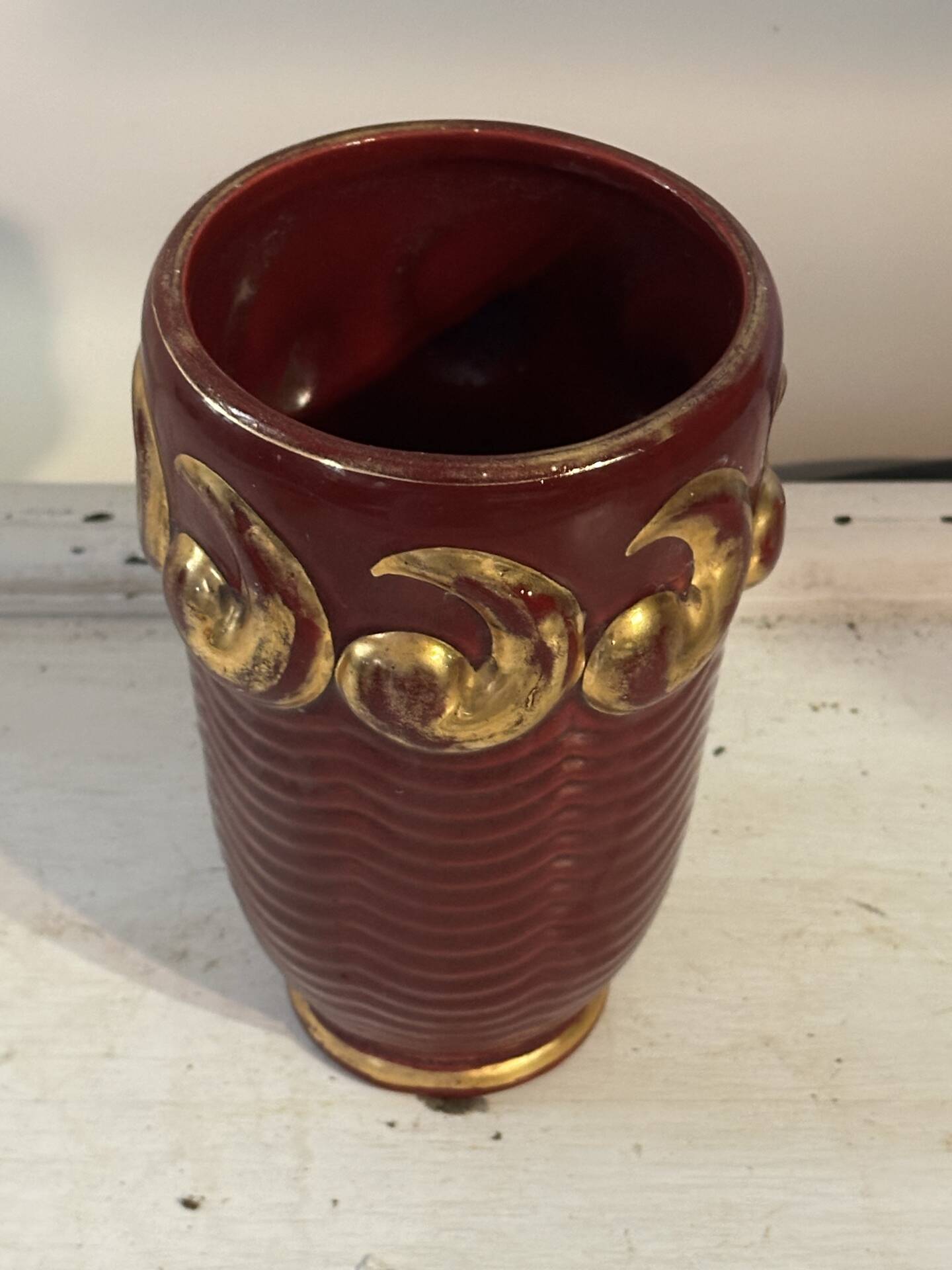 Mid-century relief vase in ruby red enhanced with gilding.