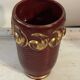 Mid-century relief vase in ruby red enhanced with gilding.