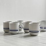 White ceramic cups with blue borders.