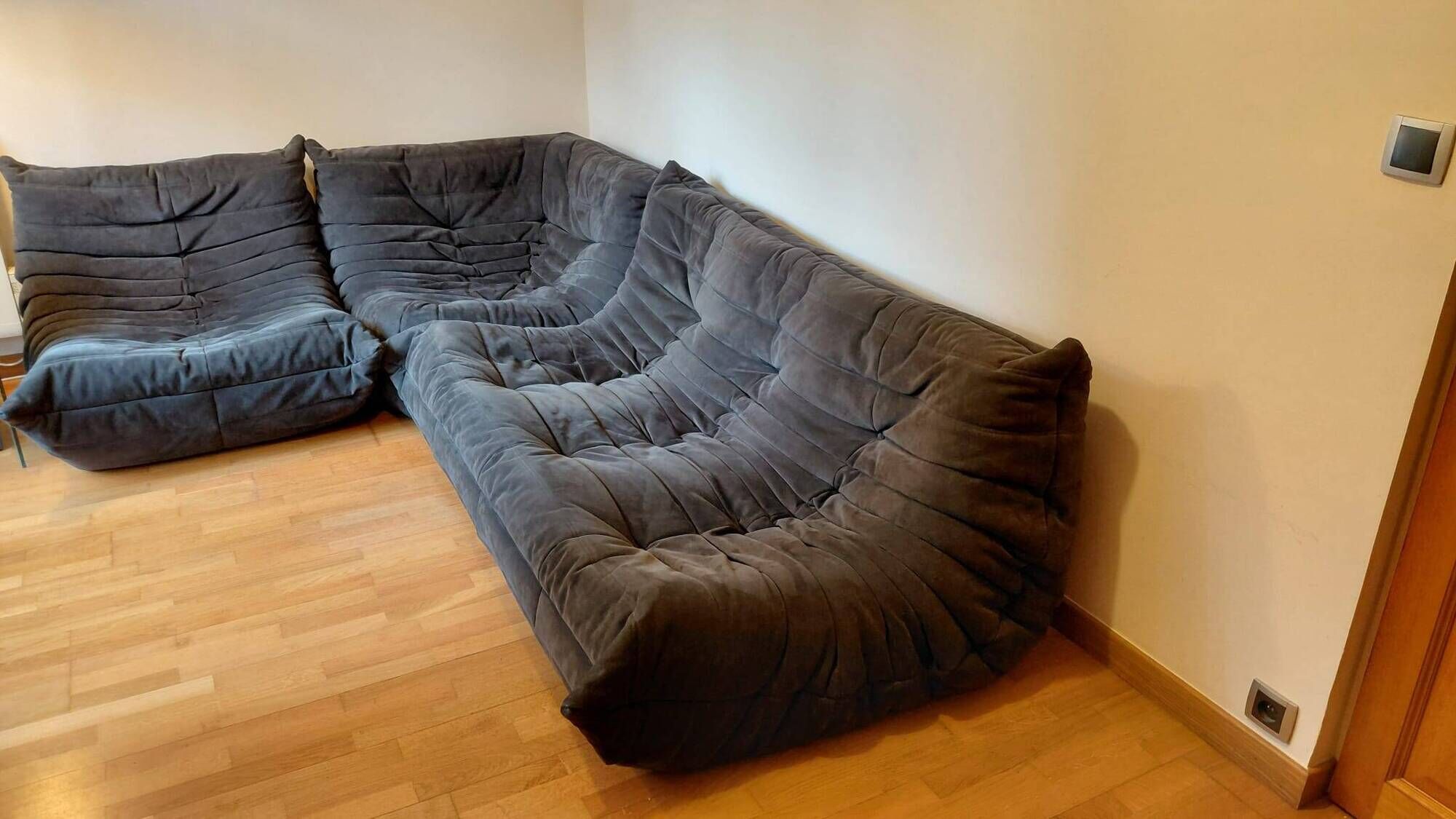Togo Set by Ligne Roset, 3-seater sofa, corner piece and armchair in grey alcantara.
