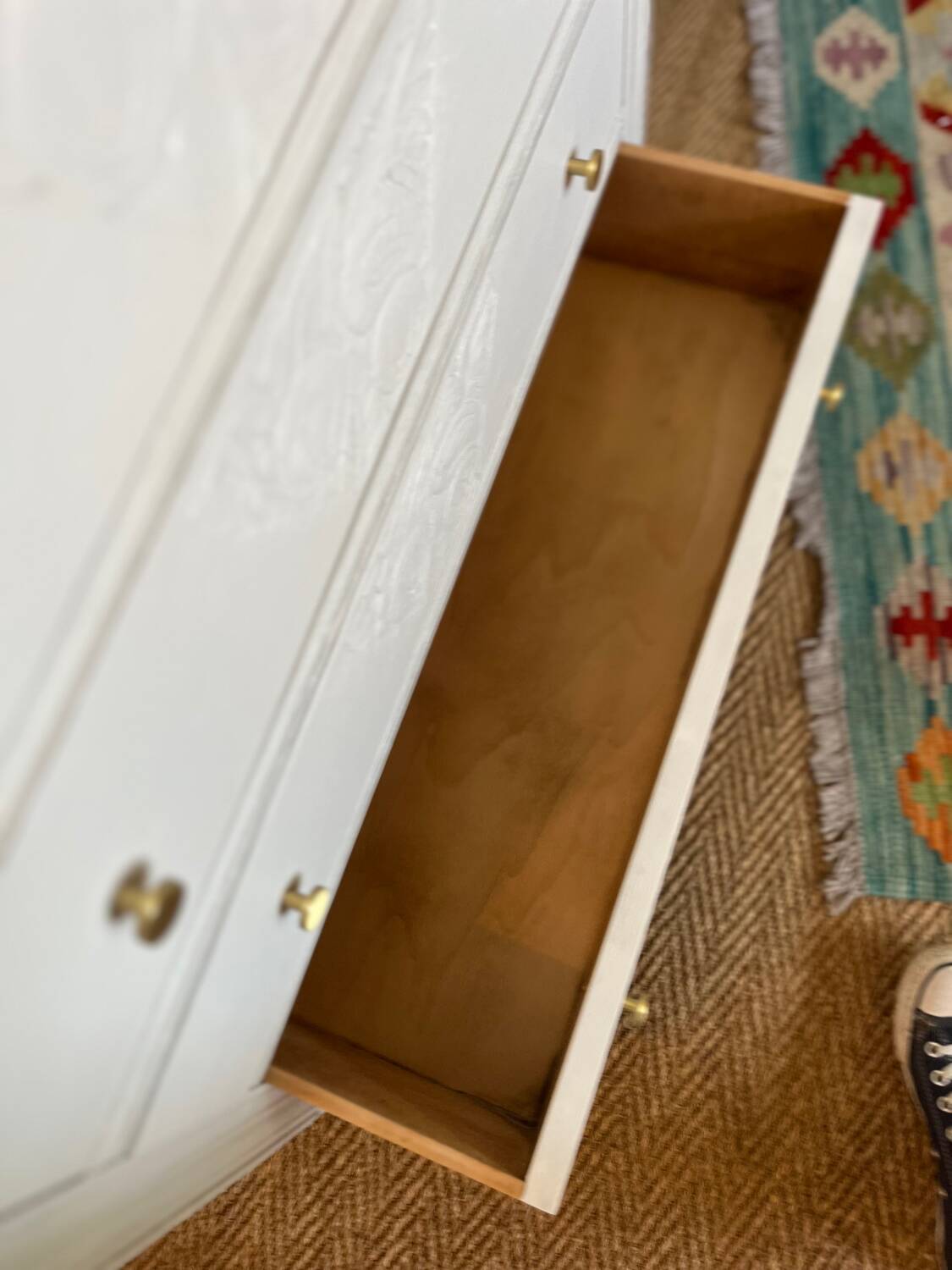 Restored wooden art deco chest of drawers with gilded handles