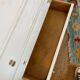 Restored wooden art deco chest of drawers with gilded handles