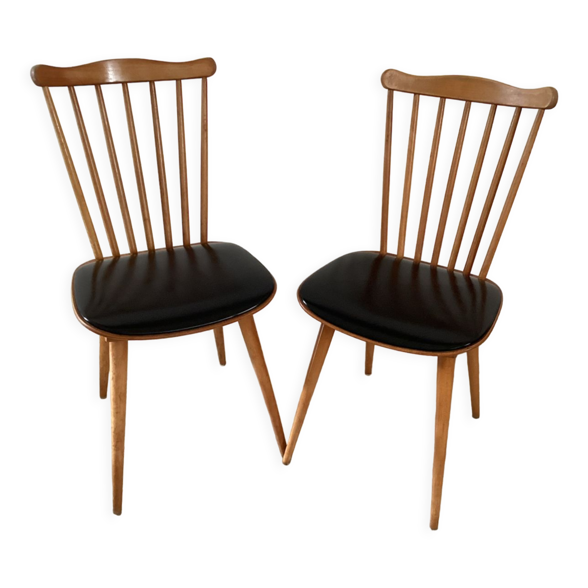 2 baumann chairs seated in imitation black leather