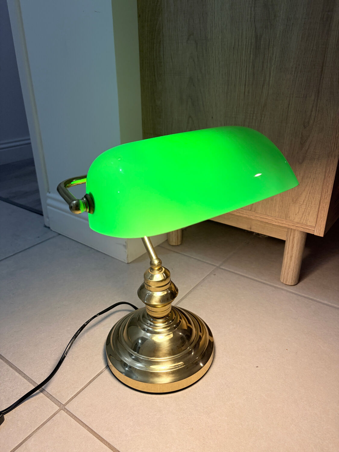Gold and green banker’s desk lamp.