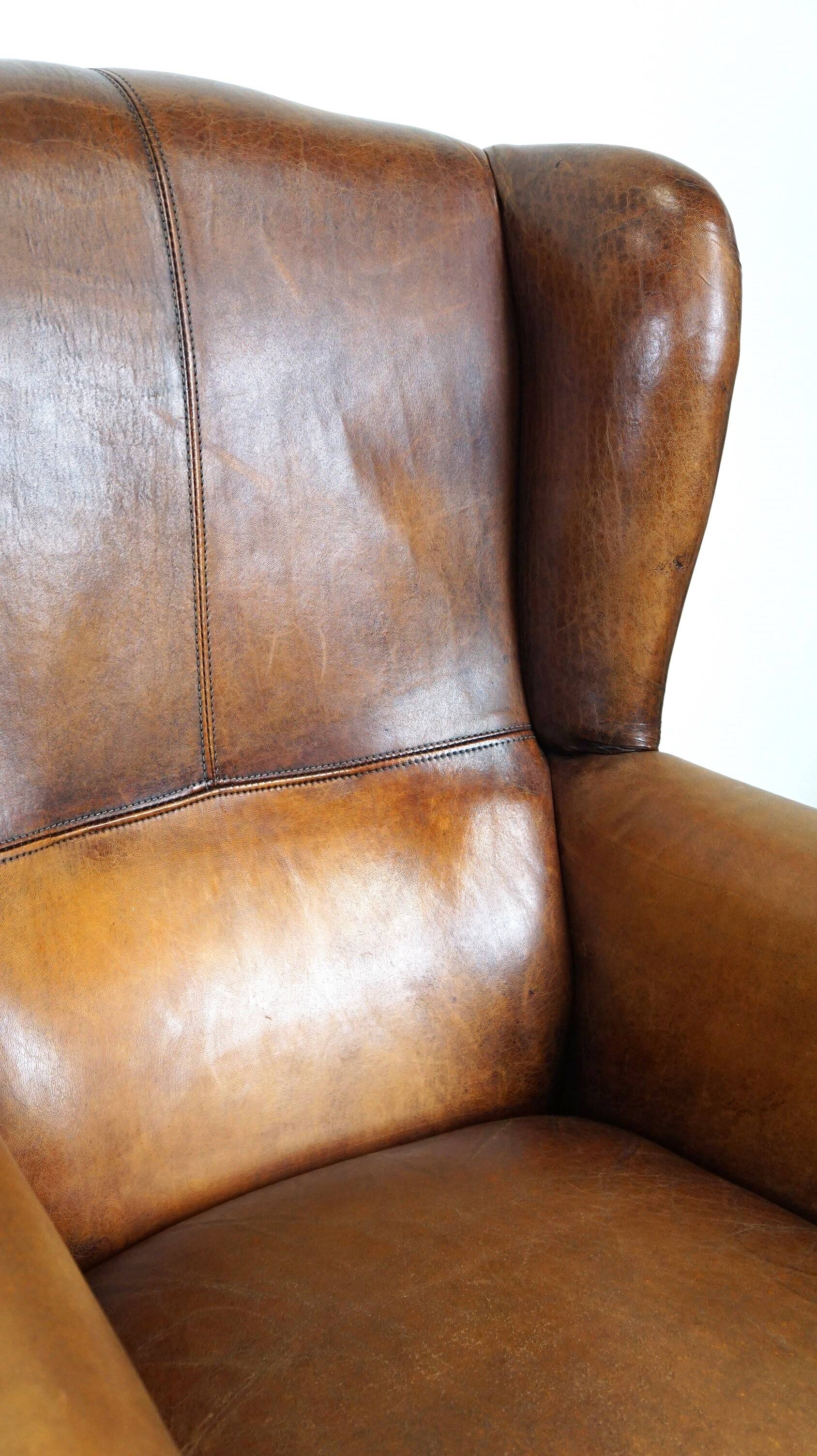 Set of 2 beautiful and correct sheep leather wingback armchairs with fixed seat cushions
