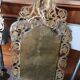 Pair of mirror wall sconces with brass candle holders.