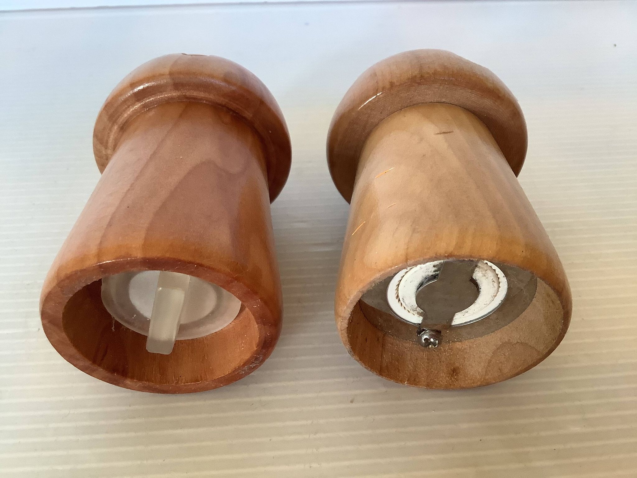 Salt and pepper shakers in wood shaped like a champagne cork.