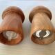 Salt and pepper shakers in wood shaped like a champagne cork.