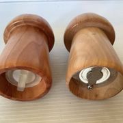 Salt and pepper shakers in wood shaped like a champagne cork.